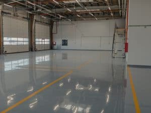 Spacious commercial area with smooth epoxy flooring, highlighting potential areas prone to chipped epoxy floor damage.